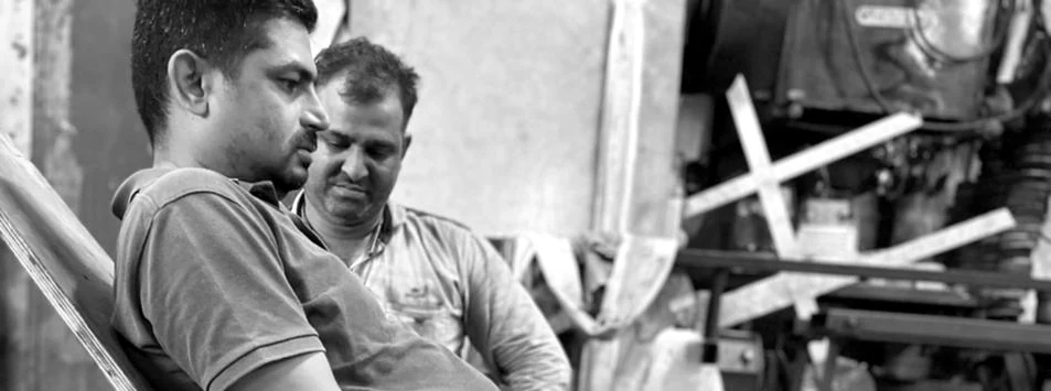 The founder of Tvastra Design LLP in conversation on a workshop floor