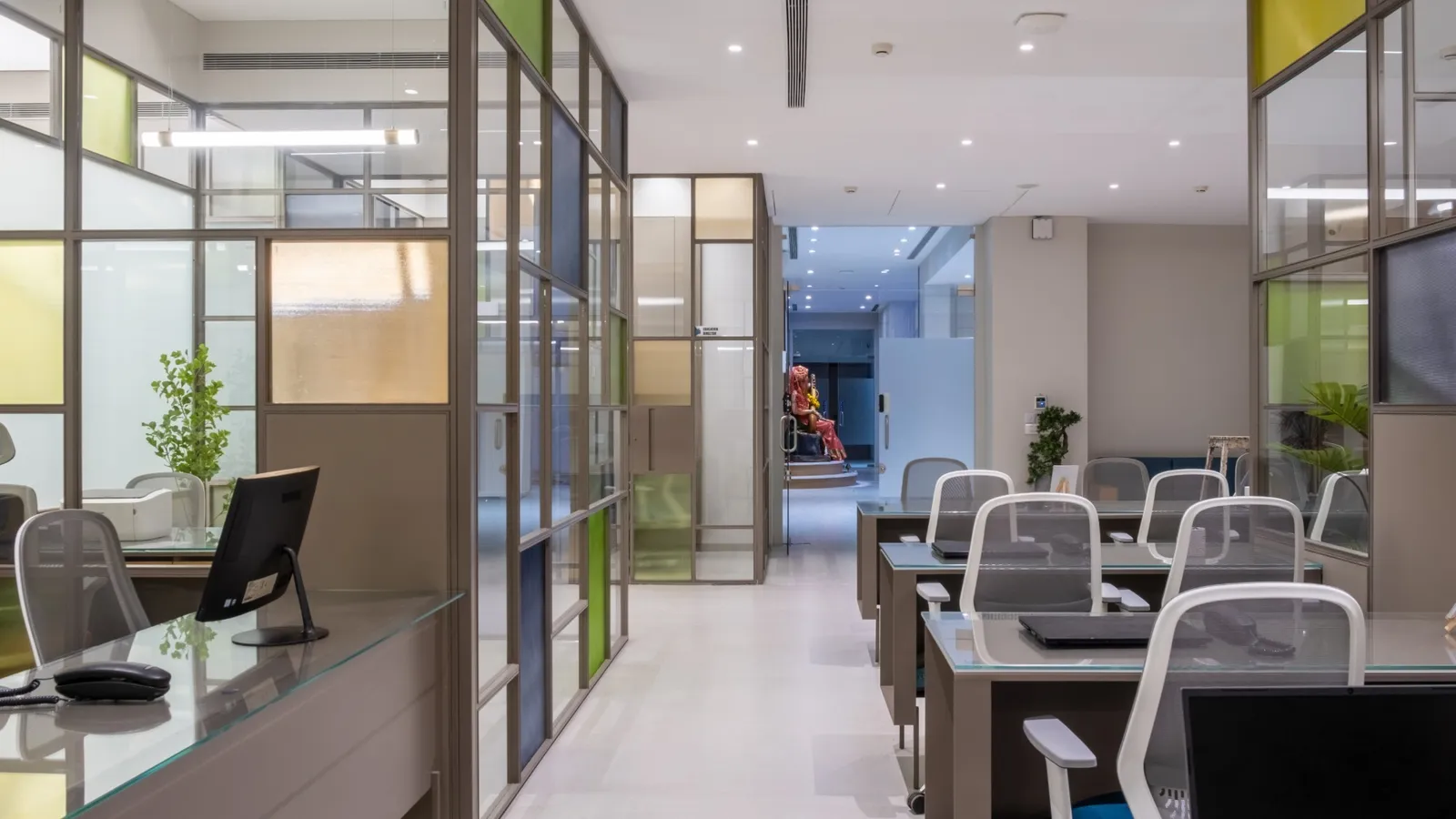 Gurukrupaa open desks behind coloured glass