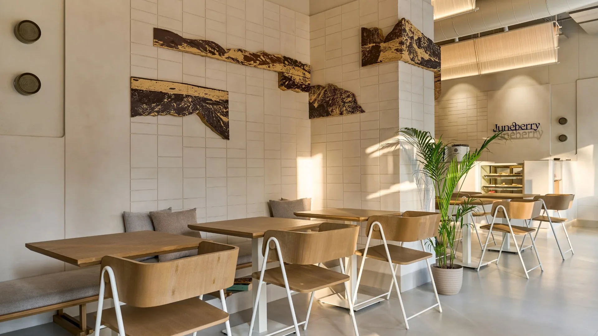 Juneberry, banana-stem canvas artworks above the banquette