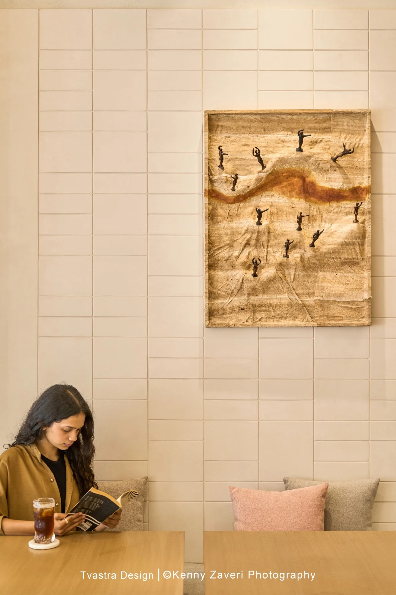 Juneberry, a guest reading beneath a banana-stem canvas